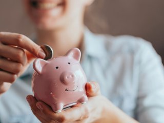 Saving money in a piggy bank