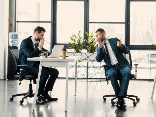 two men in the office whispering