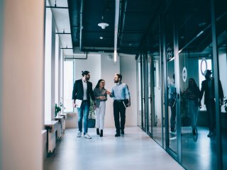 three people in a modern office building