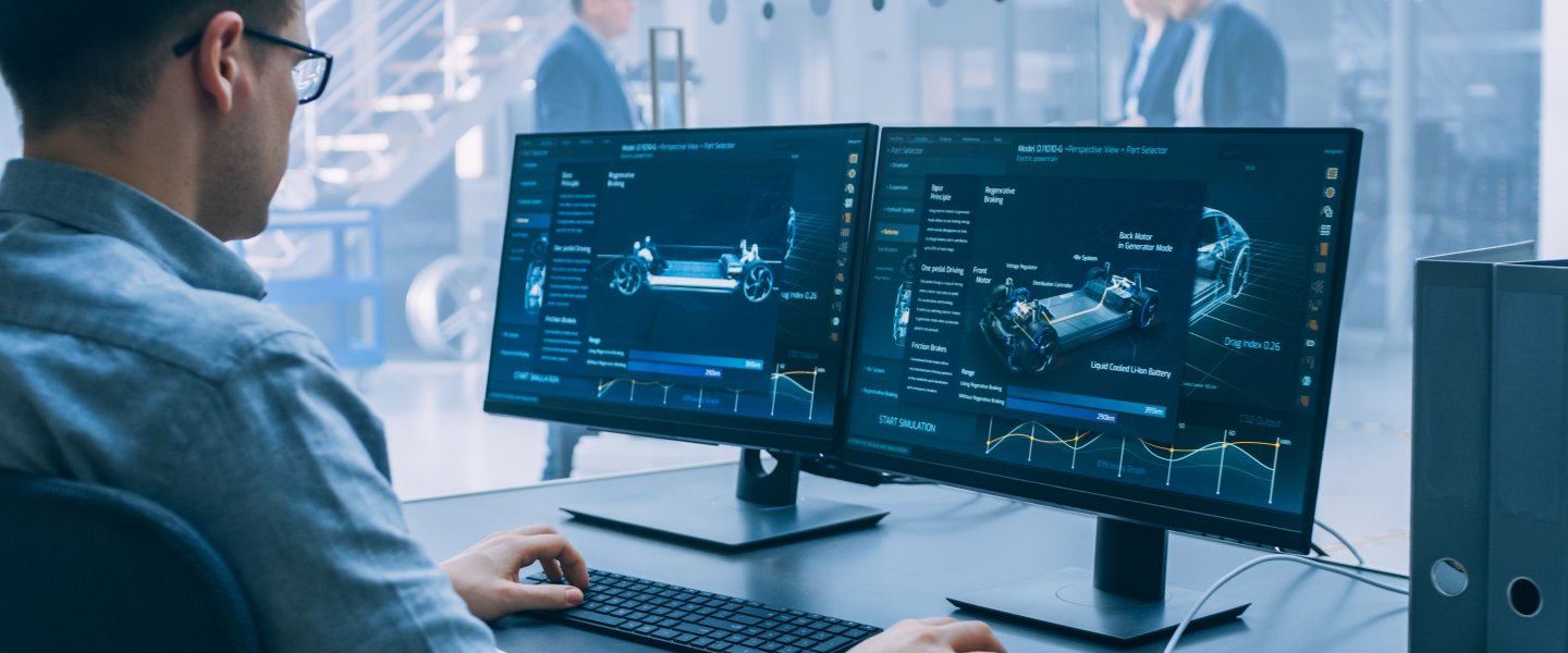 Man working on PC with two screens