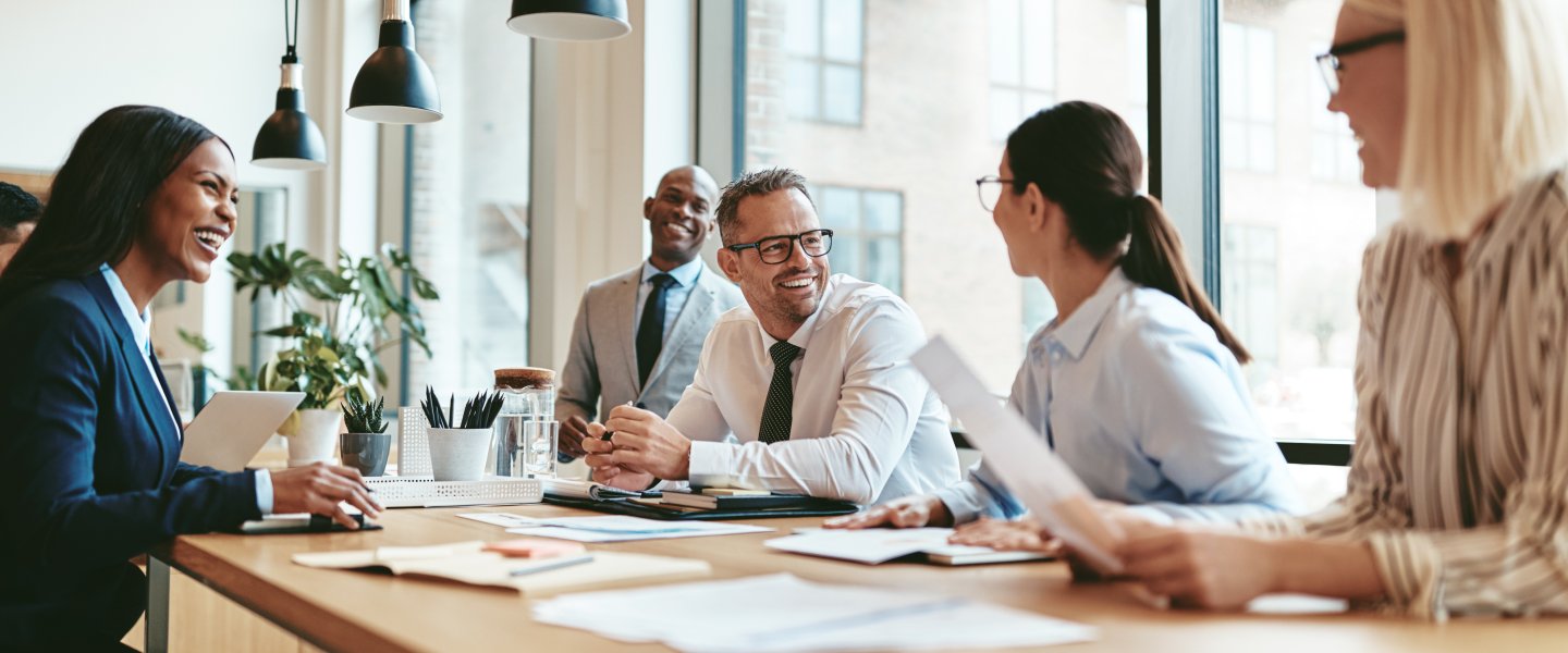 People at a meeting and laughing