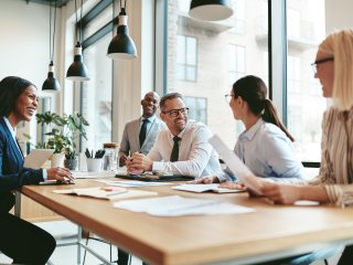 People at a meeting and laughing